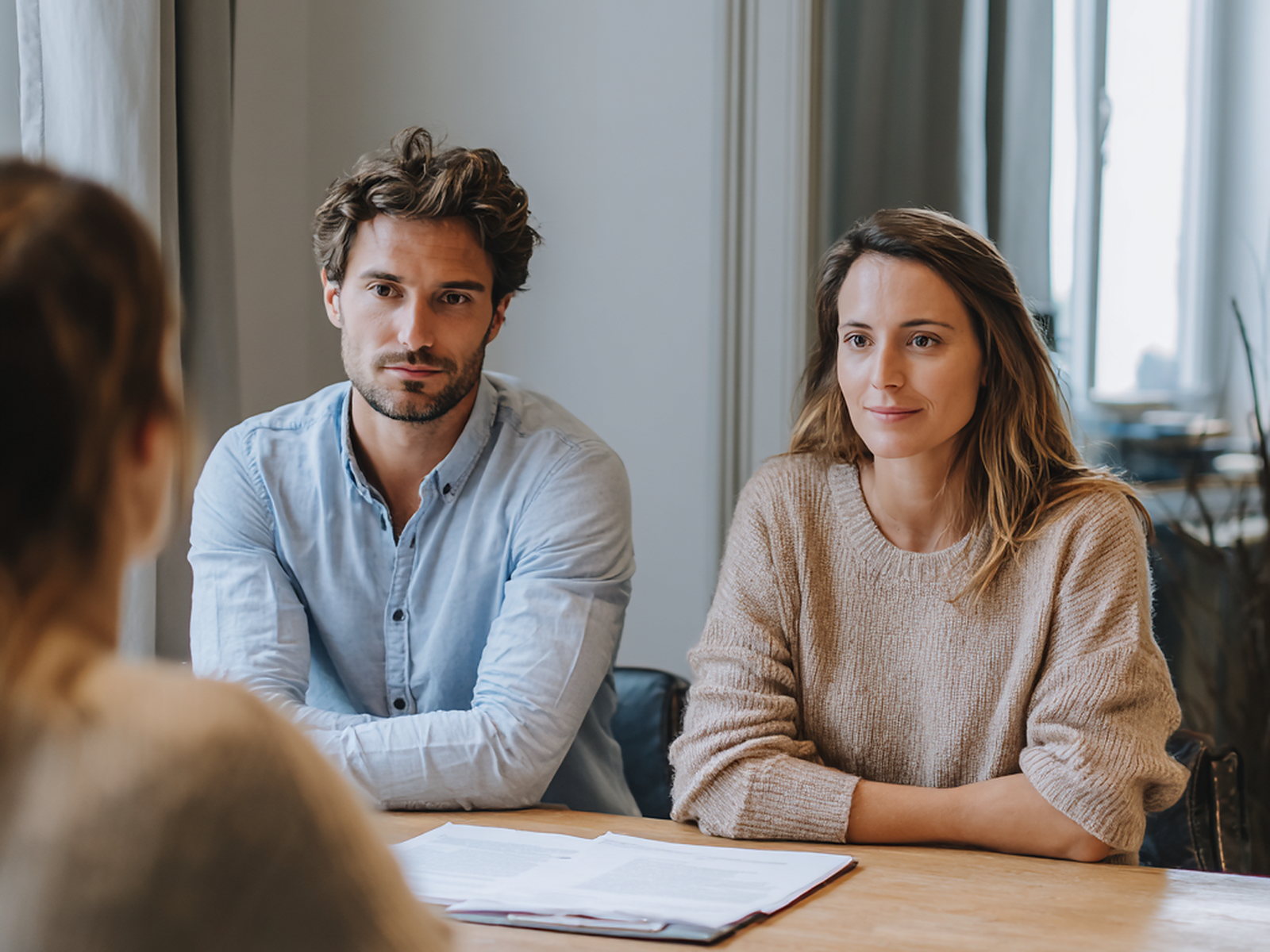 A couple meeting with an adviser at a table